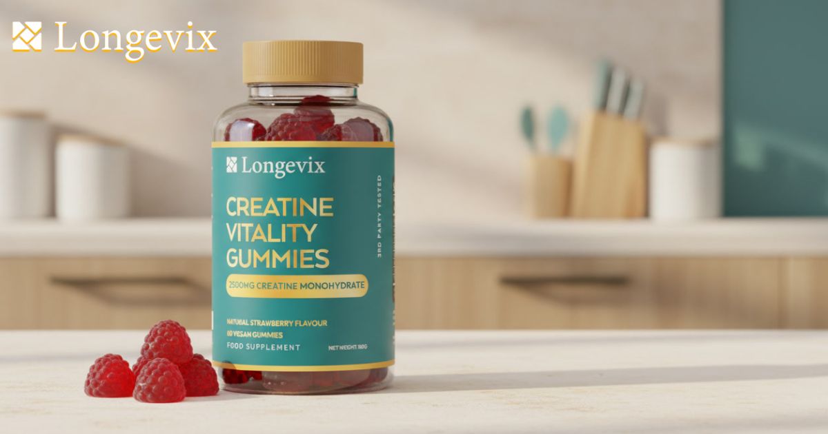 Longevix Creatine Vitality Gummies bottle with four red gummies on a clean stone surface.
